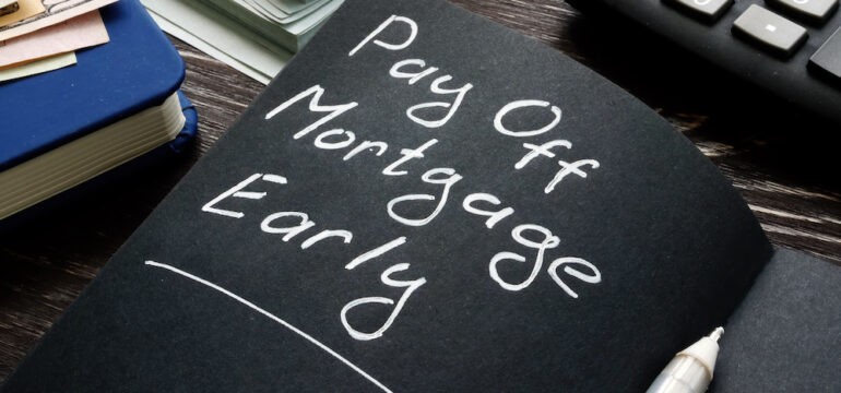 Accelerating Your Mortgage Payments. Pay off mortgage early memo on the black page.